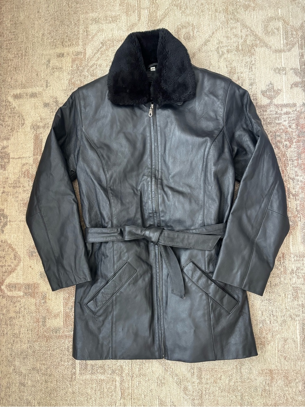 Model off duty 90s Y2K black genuine leather jacket with faux fur collar